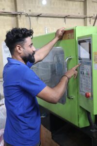 Factory worker operating machinery, showcasing industrial work in Karachi, Pakistan.